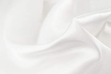 A twisted piece of white fabric. White material or texture with waves and folds. Wrinkled white...