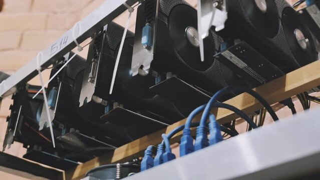 Home made crypto currency mining equipement in aluminium case with motherboard, graphic cards and PCIe powered extender risers.