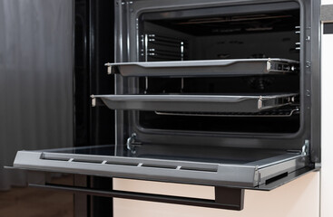 new electric oven built in with trays on telescopic rails. Modern kitchen furniture. selective...