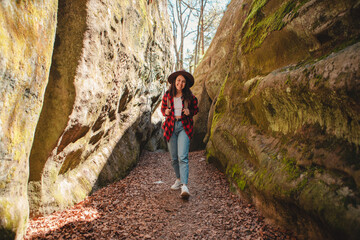 woman hiker with backpack walking by trail