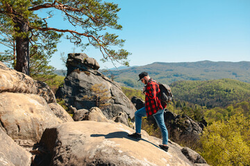 man hiker with backpack at dovbush rocks