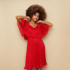 Beauty portrait of African American girl with afro hair. Beautiful black woman in red dress....