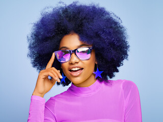 Beauty portrait of African American girl in colored holographic sunglasses. Beautiful black woman...