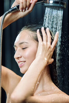 A young girl bathed in a shower