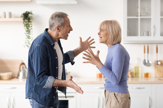 Elderly couple arguing during cooking lunch at kitchen - Powered by Adobe