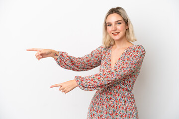 Young caucasian woman isolated on white background pointing finger to the side and presenting a product