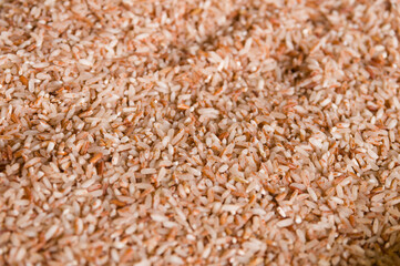 Closeup of healthy peeled heap of red rice