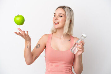 Young caucasian woman isolated on white background with an apple and with a bottle of water