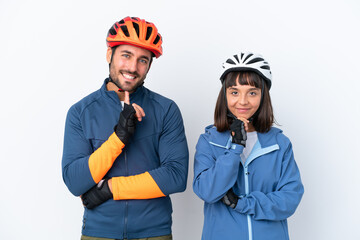 Young cyclist couple isolated on white background smiling and looking to the front with confident face