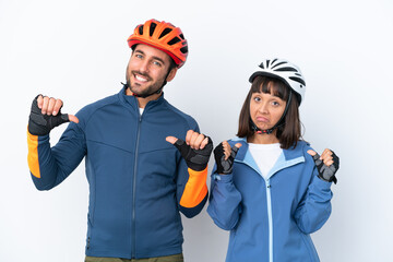 Young cyclist couple isolated on white background proud and self-satisfied in love yourself concept