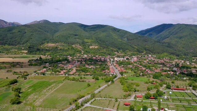 Rose fields and Skobelevo village near Damascena Complex and Rose oil distillery in Rose Valley, Bulgaria, 4k