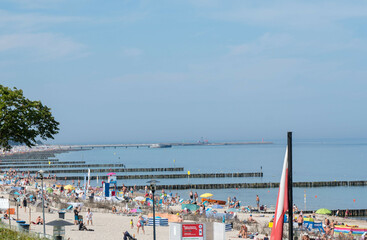 wakacje ludzie odpoczywają latem na plaży w Kołobrzegu - obrazy, fototapety, plakaty