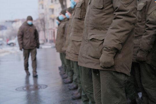 Soldiers of Ukrainian army are standing in the town uniform.