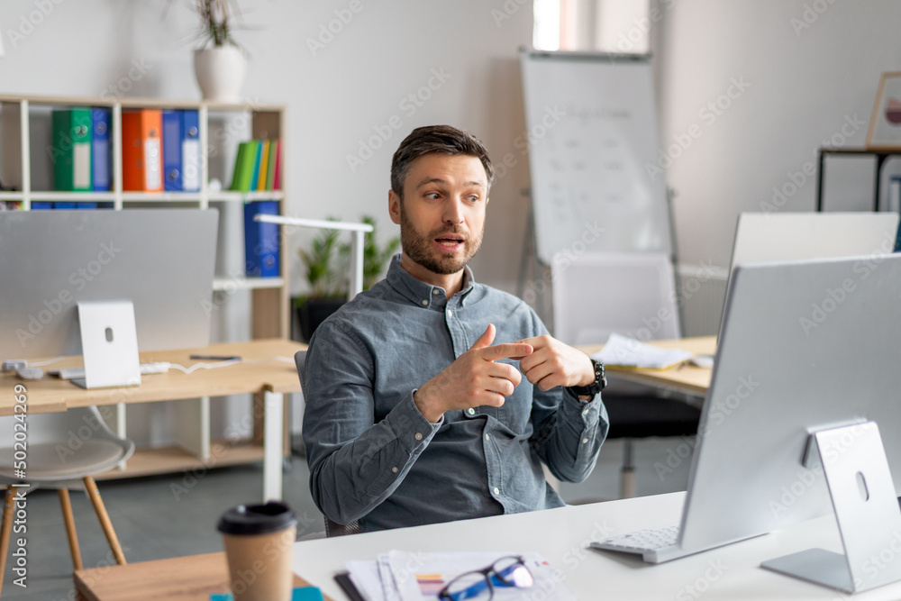 Poster video conference. portrait of mature businessman having web call using modern computer while sitting