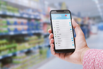 Woman checking her grocery list on the phone