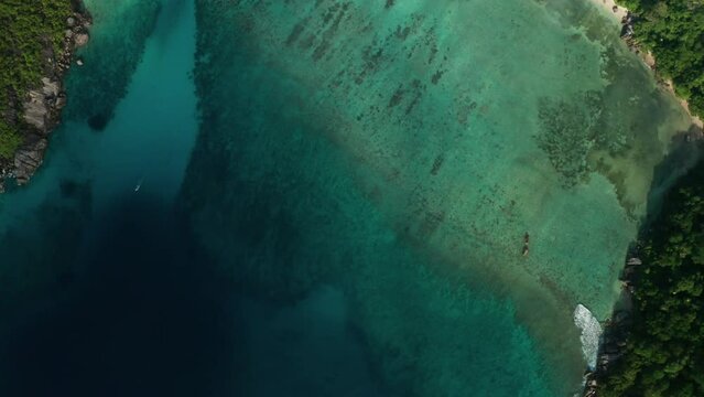 Aerial flat slider over Marine National Park in bay Baie Ternay, Mahe