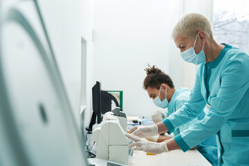 Two collegues are working in clinic laboratory