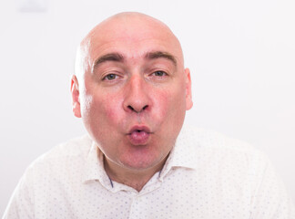portrait of bald adult elderly man on white background