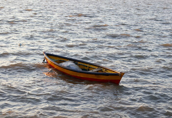 Beautiful landscape of Fishing boats on the sea. one red and yellow colors single boats and very small boats for fishing. located in Diu district of Union Territory Daman and Diu, India