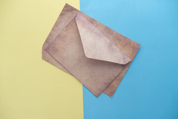 envelope , empty paper on color background 