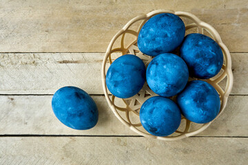 Blue painted eggs on a wooden background