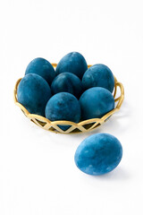Blue painted eggs on a white background, vertical shot