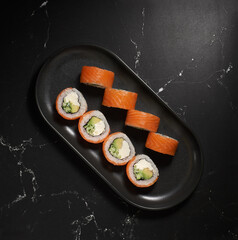 Philadelphia sushi roll with salmon, cucumber, avocado, cream cheese. Sushi menu. Japanese food