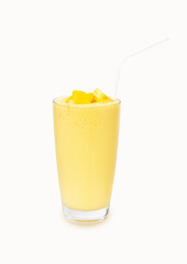 Fresh Mango ripe organic yellow smoothie honey mix in glass with straw.  Isolated on white background.There is vitamin C. Perfect for summer drink. Garnish. Ripe mangoes are popular all over world. 