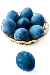 Blue painted eggs on a white background, vertical shot