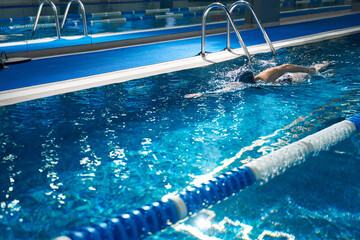 Female swimmer breathing performing the crawl stroke