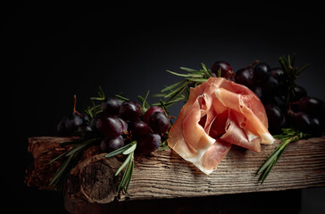 Prosciutto with grapes and rosemary.