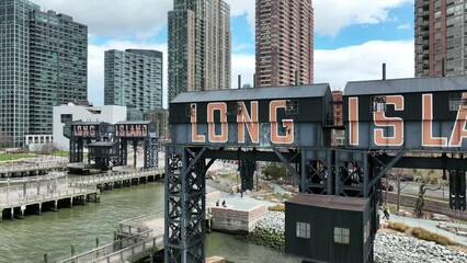 Long Island sign with city buildings on water in New York