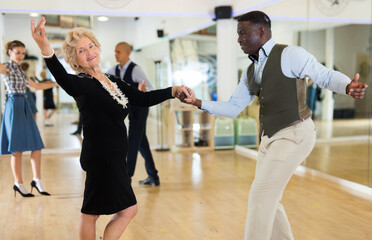 Two professional dancers practicing lindy hop in dance class