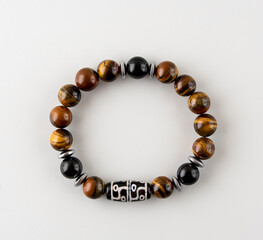 Bracelet made of amethyst and quartz,. A bracelet made of natural stones on the hand. Handmade jewelry on a white background.