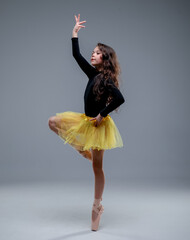 ballet dancer in yellow tutu, rythmic gymnastic