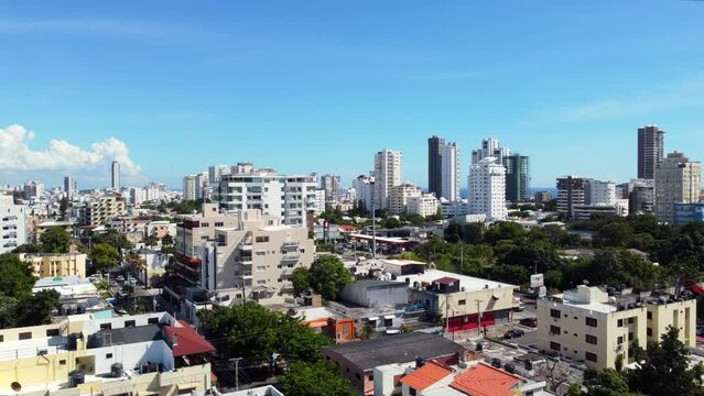 Lifting up above the big Latin American city on On the seashore. Skyscrapers and clear blue sky in the background. Santo Domingo, Dominican Republic
