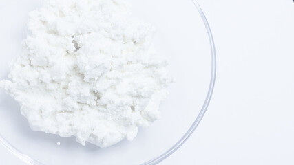cottage cheese in a glass transparent bowl isolated on a white background