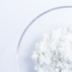 cottage cheese in a glass transparent bowl isolated on a white background