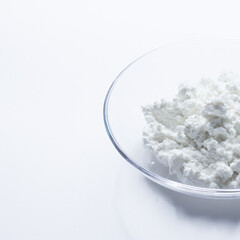 cottage cheese in a glass transparent bowl isolated on a white background