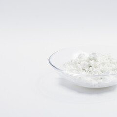 cottage cheese in a glass transparent bowl isolated on a white background