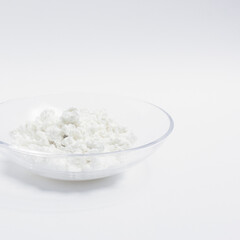 cottage cheese in a glass transparent bowl isolated on a white background