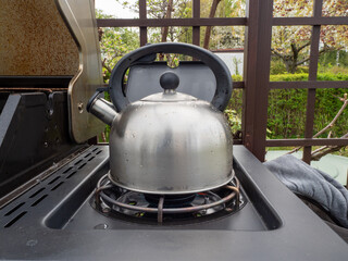 Kettle on gas grill. Kettle on a gas stove.