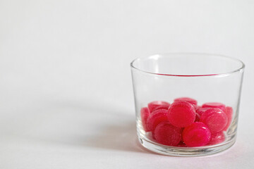 Red round tablets for the treatment of throat in a pillbox