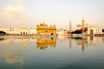 The golden temple of Sikh religion at sunset in Amritsar, Punjab, India.