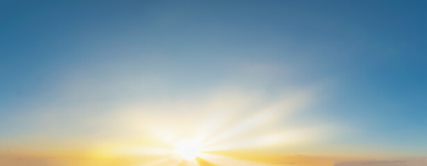 Sky blue and orange light of the sun through the clouds in the sky
