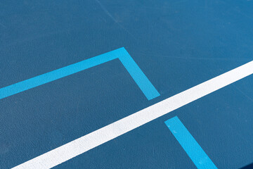 Blue tennis court with white lines combined with light blue pickleball lines