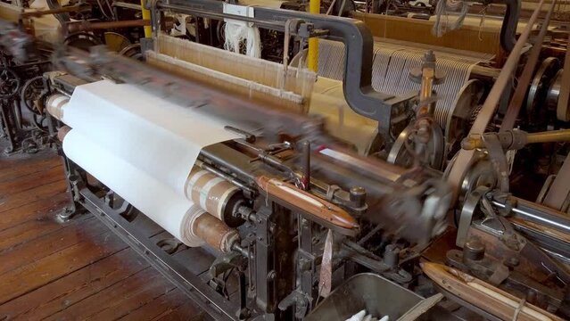 A cotton loom at a working textile mill, with audio. Seamless loop