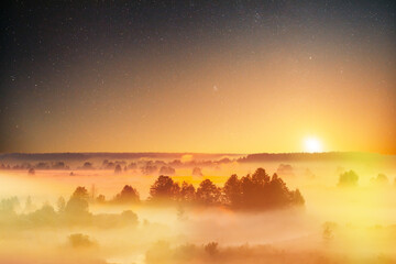 Amazing stars starry sky above Misty foggy Landscape Scenic View Of Morning Sky With Rising Sun Above Forest. night sky stars starry sky Glowing Stars starlight.