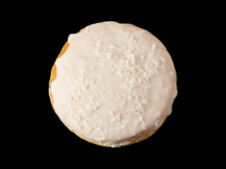Closed donut in white glaze with on a black background.
