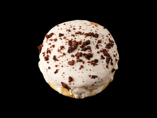 Closed donut in white glaze with chocolate chips on a black background.